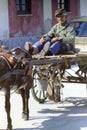 PROCIDA, ITALY, 1976 - An old man observes with curiosity and attention from his cart