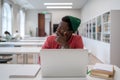Pensive Black student man looking into distance while studying in library, disinterested in study Royalty Free Stock Photo