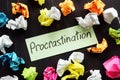 Procrastination sign and paper balls