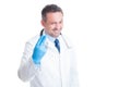 Proctologist showing two fingers with surgical latex gloves