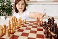 Prodigy girl moving a white pawn