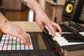 Producer makes a music on MIDI keyboard.