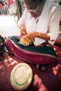 Product by hand made, hand of Senior Ethnic woman holds took bamboo stripes to weave into different. Royalty Free Stock Photo