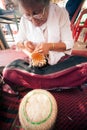 Product by hand made, hand of Senior Ethnic woman holds took bamboo stripes to weave into different. Royalty Free Stock Photo