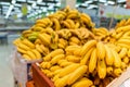 Product Image Tropical Fruit Yellow Bananas on shelves and counters in the supermarket.