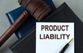 PRODUCT LIABILITY - words on a white sheet with leather notebooks, a judge\'s hammer and a pen