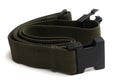 A coil of olive dark green canvas waist military belt white backdrop