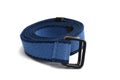 A product photo taken on a well used navy blue canvas belt with rusted buckles