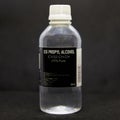 Bottle of ISOPROPYL ALCOHOL for medical and industrial use 99% pure on a black background. colorless, flammable compound Royalty Free Stock Photo