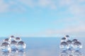 Product placement and advertising background. Glass balls on empty marble surface against blue sky with clouds. Backdrop for Royalty Free Stock Photo