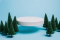 Product podium with Christmas pine trees on pastel blue background. Concept scene stage showcase for promotion, sale, banner Royalty Free Stock Photo