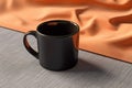 Product presentation, black coffee mug mockup on linen napkin Empty mug Royalty Free Stock Photo