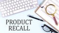 PRODUCT RECALL text on blue background with keyboard and clipboard, business concept