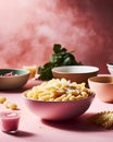 Product shot of a pink bowl of pasta against a pink background, AI-generated.