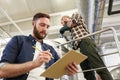 Men with clipboard at brewery or beer plant kettle Royalty Free Stock Photo