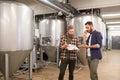 Men working at craft brewery or beer plant Royalty Free Stock Photo