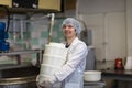 Production of cheese in dairy, worker with forms