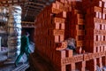 Production of clay bricks at a brick factory. Ready hot red bricks stacked on pallets cools after kiln firing