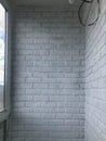 Production of decorative plaster, bricks on the balcony wall. the final stage, painting the wall. the plaster bricks are painted Royalty Free Stock Photo