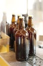 Production line, beer and bottles in factory, brewery or manufacturing plant. Alcohol glass, conveyor machine and Royalty Free Stock Photo