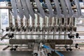 Production line for filling bottles with water. Closeup