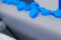 Production line - many blue plastic bottle caps falling from conveyor belt