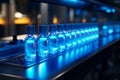 A production line in a modern laboratory is where bottles are filled with glowing liquid Royalty Free Stock Photo