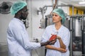 Production line supervisor and worker work together in beverage production line Royalty Free Stock Photo