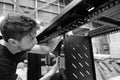 Production line worker seen assembling data cabinets at a factory.