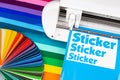 Production making sticker with plotter cutting machine sheets of colorful various rainbow colored vinyl fim with color fan. guide Royalty Free Stock Photo