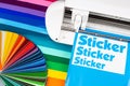 Production making sticker with plotter cutting machine sheets of colorful various rainbow colored vinyl fim with color fan. guide