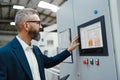 Production manager standing in modern industrial factory, controlling production process. Manufacturing facility with Royalty Free Stock Photo