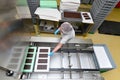 Production of pralines in a factory for the food industry - conveyor belt worker with chocolate Royalty Free Stock Photo