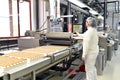 Production of pralines in a factory for the food industry - conveyor belt worker with chocolate Royalty Free Stock Photo