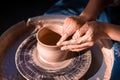 Women hands. Potter at work. Creating dishes. Potter& x27;s wheel. Dirty hands in the clay and the potter& x27;s wheel with the Royalty Free Stock Photo