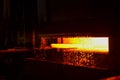 Hot iron in smeltery held by a worker. Melting of metal in a steel plant Royalty Free Stock Photo