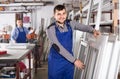 Production workers in coverall with different finished PVC profiles and windows at factory Royalty Free Stock Photo