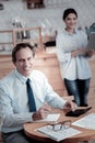 Positive man smiling while a woman holding a laptop Royalty Free Stock Photo