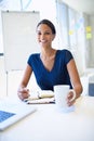 Productive day at the office... What a great feeling. A young businesswoman writing in a notebook while working at her Royalty Free Stock Photo