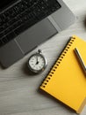 Productivity Tools on a Desk With a Laptop, Stopwatch, Notepad, and Pen Highlighting a Focused Work Environment Royalty Free Stock Photo