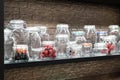 Products and accessories for home canning. Various glass jars on a shelf in a shop window on sale