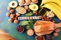 Products containing magnesium: bananas, almonds, avocado, nuts and spinach and eggs on background Royalty Free Stock Photo