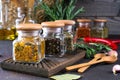 Products for cooking in kitchen, kitchen utensils, herbs, colorful dry spices in glass jars on dark Royalty Free Stock Photo