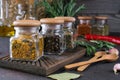 Products for cooking in kitchen, kitchen utensils, herbs, colorful dry spices in glass jars Royalty Free Stock Photo