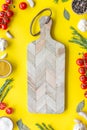 Products frame and cutting board on yellow background top view mockup Royalty Free Stock Photo