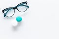 Products help see better. Glasses with transparent optical lenses and eye lenses on white background top view copy space