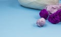 Products for needlework, knitting. Balls of pink, purple yarn on a blue background. Royalty Free Stock Photo