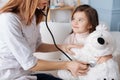 Professioal doctor examining fluffy toy