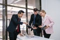 Profession businesspeople office workers working in team conference on a laptop with project planning document on meeting table Royalty Free Stock Photo