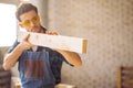 Carpenter testing wood plank evenness at workshop Royalty Free Stock Photo